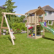 Speeltoestel Jungle Gym Cottage douglas met glijbaan donker groen en 2-schommel module